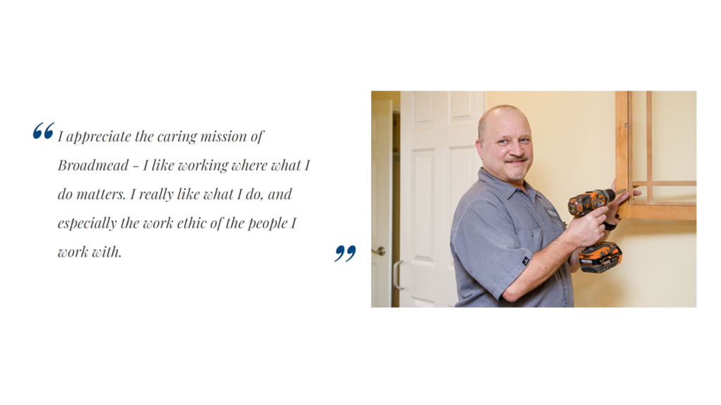 broadmead man with a drill hanging a mirror